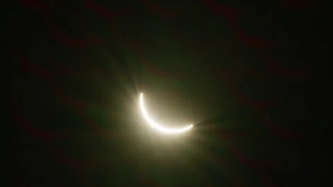 A Partial Solar Eclipse Shows The Sun In A Crescent Shape, Emitting Radiant Stock Footage 297722959