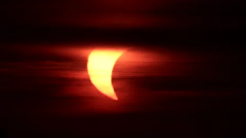 Partial solar eclipse at sunset with an airplane silhouette transit Stock Footage 342278649