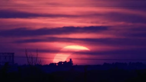 Partial solar eclipse at sunset over Rome skyline with Gasometer silhouette.. Stock Footage 342285765