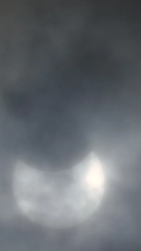 Partial solar eclipse through cloud, UK, 29th March 2025 Stock Footage 305311526