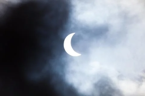 Partial solar eclipse through clouds Fotos Stock