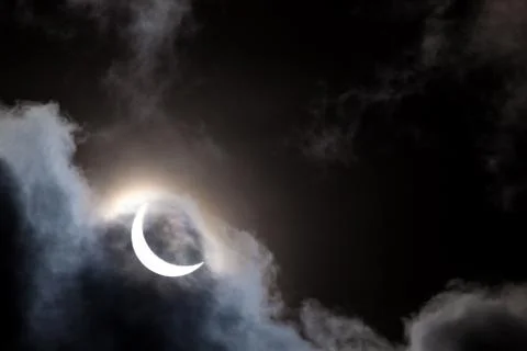 Partial solar eclipse through clouds Fotos Stock