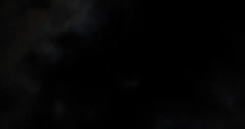 Partial solar eclipse viewed through clouds in a nighttime sky Stock Footage 281706949