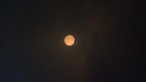 Partial Solor Eclipse Seen Through Clouds April 8 2024 - 02 Stock Footage 271443694