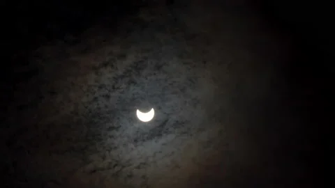 Partial Sun Eclipse on 25 of October 2022. Fast Moving Clouds Over Solar Eclipse Stock Footage 219939848