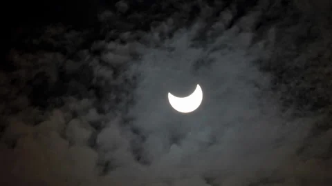 Partial Sun Eclipse on 25 of October 2022. Fast Moving Clouds Over Solar Eclipse Stock Footage 225666094