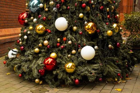 Partial view of the base of a decorated Christmas tree outdoor Stock Photos