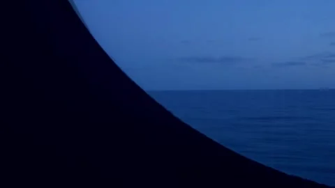 Partial view of boat window timelapse over ocean at sunset Stock Footage 258947444