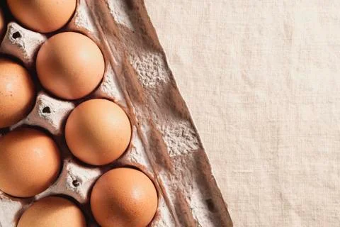 Partial view of a box of fresh brown eggs Stock Photos