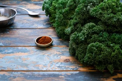 Partial view of chef pouring sesame seeds on a small bowl set on styling colo Stock Photos