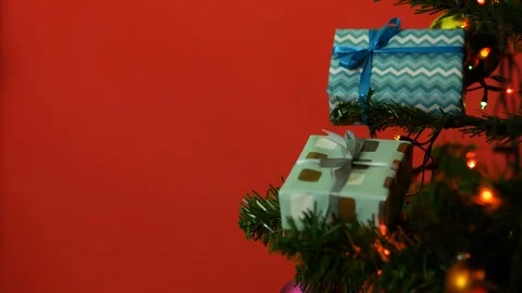 Partial view of christmas tree with gift boxes Stock Footage 122675421