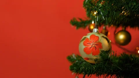 Partial view of christmas tree with toy ball on the red background. Video stock 122675418