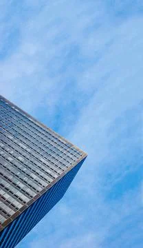 Partial view of a corporate skyscraper from the bottom in front of cloudy ... Stock Photos