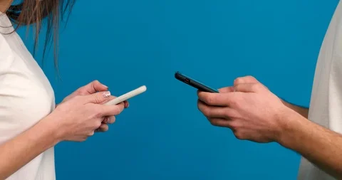Partial view of couple using smartphones isolated on blue background Stock Footage 123967794