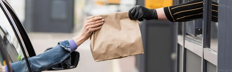 Partial view driver taking takeaway Stock Photos