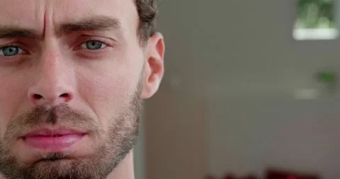 Partial view of the face of Caucasian worried, bewildered man, touching bearded Видео 219913657