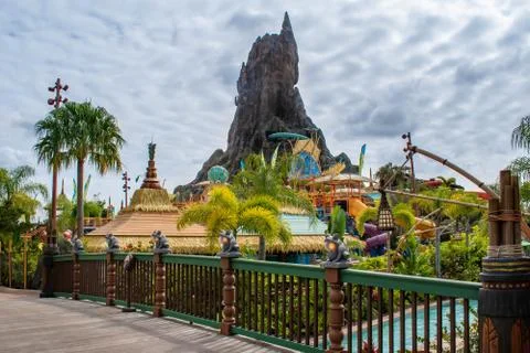 Partial view of Krakatau volcano on cloudy sky background at Volcano Bay water p Stock Photos
