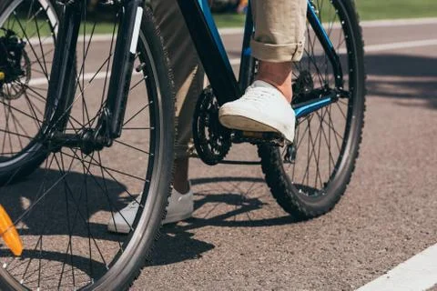 Partial view of man riding bicycle in summer park 库存照片