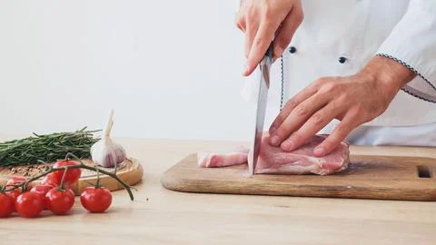 Partial view man slicing beef Stock Photos