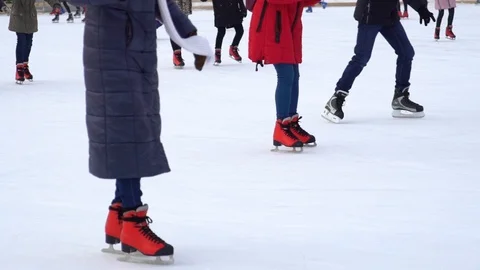 Partial view of people skating on ice rink in winter in slow motion Stock Footage 101687662