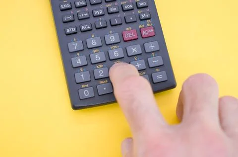 Partial view of a person doing computations on a scientific calculator Stock Photos