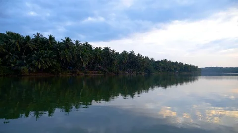 Partial View of a town on the river bank with several tall trees, Kerela, India 動画素材 120836571