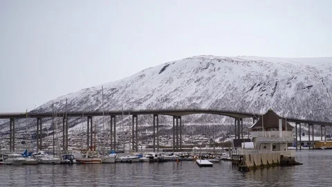 Partial view of the Tromsø Bridge and some boats seen from the port Stock Footage 126213028