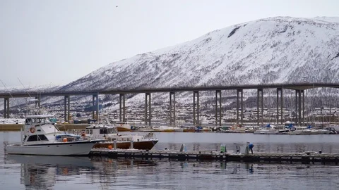 Partial view of the Tromsø Bridge and some boats seen from the port Stock Footage 126213605