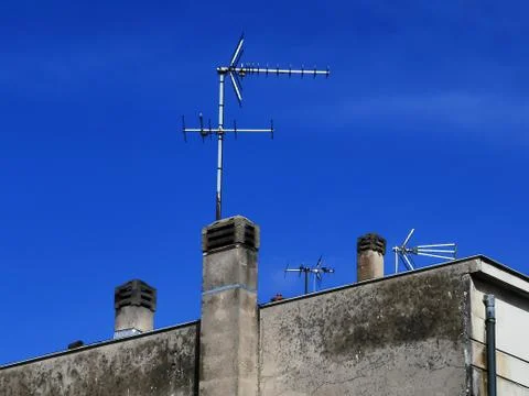 Partial view of a typical house with chimney against blue sky Stock Photos