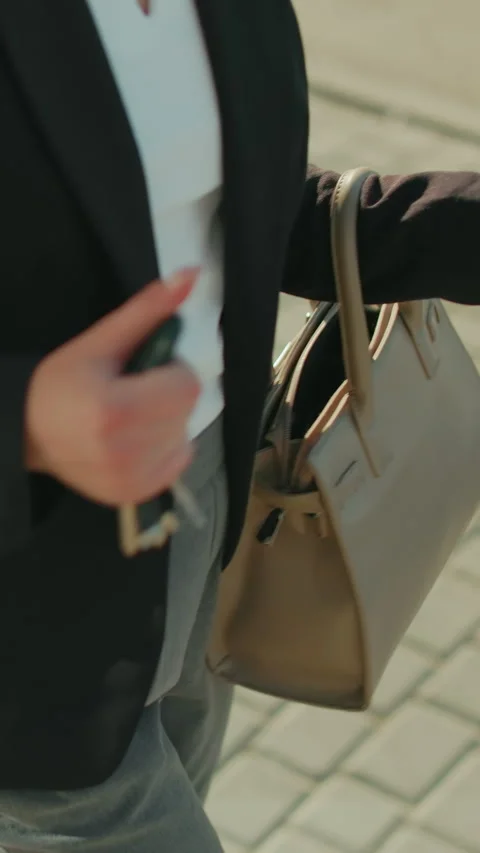 Partial View of Woman Retrieving Key from Handbag with People and Cars Nearby Vídeo Stock 319758074