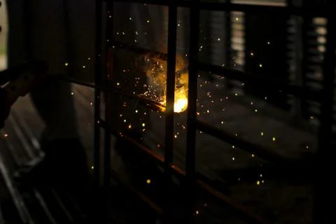 Partial view of worker welding metal with sparks at factory.Selective focus . Stock Photos