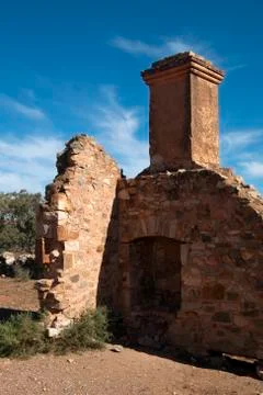 Partial wall with fireplace and chimney at abandoned settlement Stock Photos