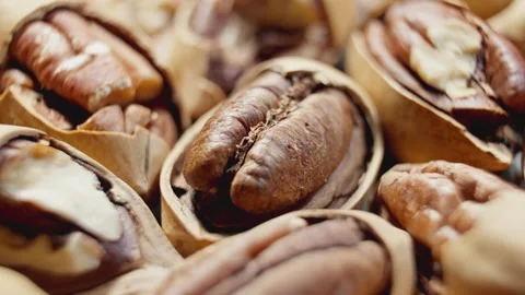 Partially cracked pecans rotating. Pile of nuts. Peeled pecans are spinning. Stock Footage 291443355
