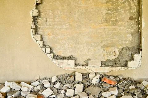 Partially destroyed wall inside an industrial building under demolition Stock Photos
