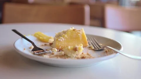 Partially Eaten Lemon Pie Slice On Plate With Forks At Café Table For Dessert Stock Footage 342212179