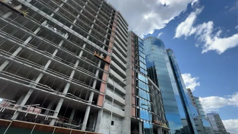 Partially glazed office building under construction. Bottom up view. Wide angle Stock Footage 195546208