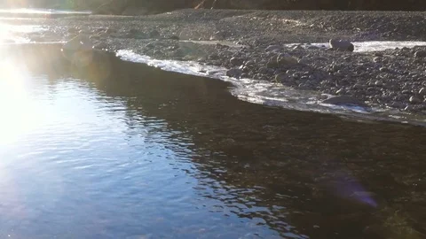 Partially iced river flowing in a mountain valley Stock-Footage 71368944