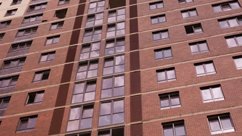 Partially installed windows on brick residential building facade Видео 343691258