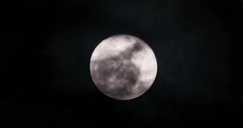 Partially shadowed moon in a dark night sky Stock Footage 153786291