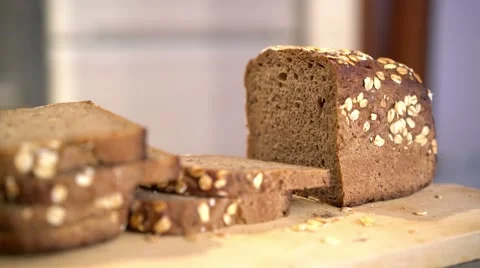 Partially sliced loaf of fresh rye bread, rack focus. Stock Footage 56151070