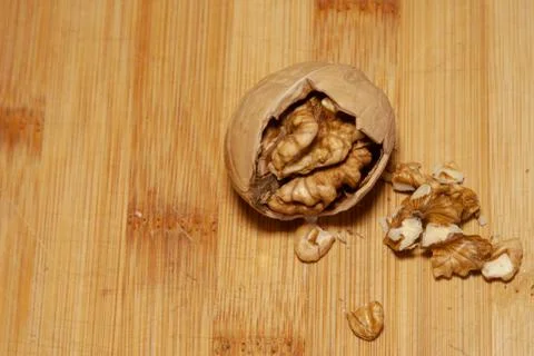 Partially split walnut on a light background Stock Photos