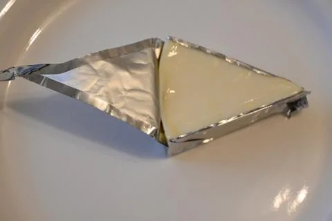 Partially unwrapped processed cheese wedge 스톡 사진