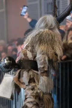 A participant in the Krampus procession is shown from behind during a natio.. 스톡 사진