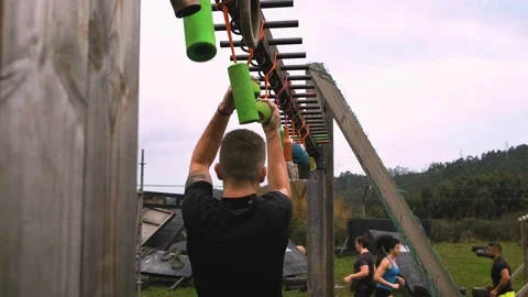 Participant obstacle course doing suspension Stock Footage 106237974