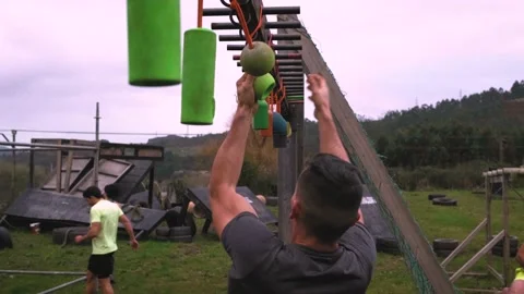 Participant obstacle course doing suspension Stock Footage 137944682