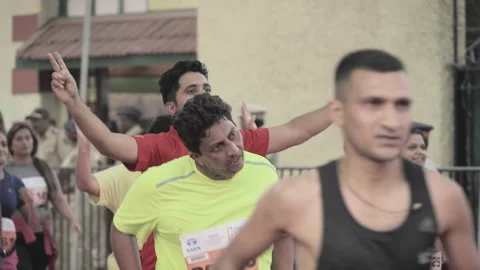 Participants are celebrating while approaching thefinish line in Mumbai Marathon Stock Footage 138215267