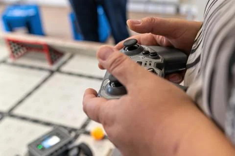 Participants control a robot with a game controller during a technology works 写真素材