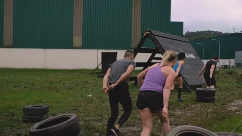 Participants in an obstacle course dragging wheels Stock Footage 112517090