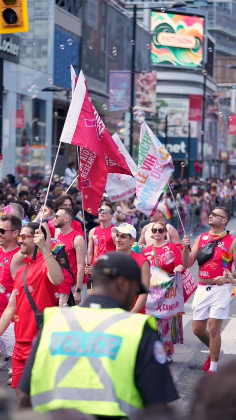 Participants in Red Shirts Marching at Pride Parade in Downtown Toronto Video stock 332018119