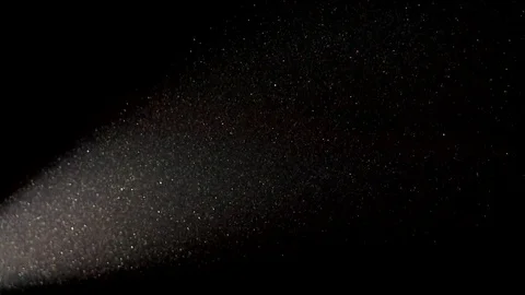 Particle of dust flies on a dark background in the light of a bright spotlight Stock Footage 82812969